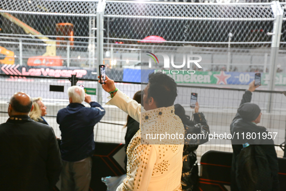 An Elvis impersonator takes a video of a Formula 1 car passing during the Formula 1 Heineken Silver Las Vegas Grand Prix in Las Vegas, Nevad...