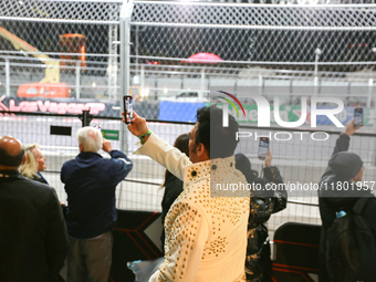 An Elvis impersonator takes a video of a Formula 1 car passing during the Formula 1 Heineken Silver Las Vegas Grand Prix in Las Vegas, Nevad...