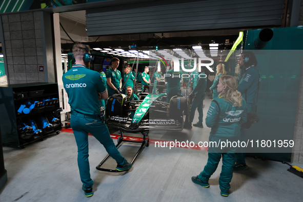 The Aston Martin team prepares in their garage ahead of Fernando Alonso driving in during the third Free Practice session of the Formula 1 H...