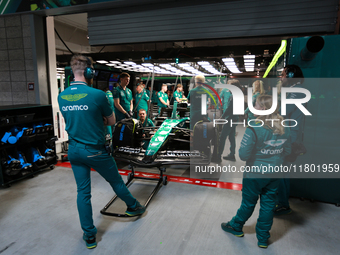 The Aston Martin team prepares in their garage ahead of Fernando Alonso driving in during the third Free Practice session of the Formula 1 H...