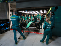 The Aston Martin team prepares in their garage ahead of Fernando Alonso driving in during the third Free Practice session of the Formula 1 H...