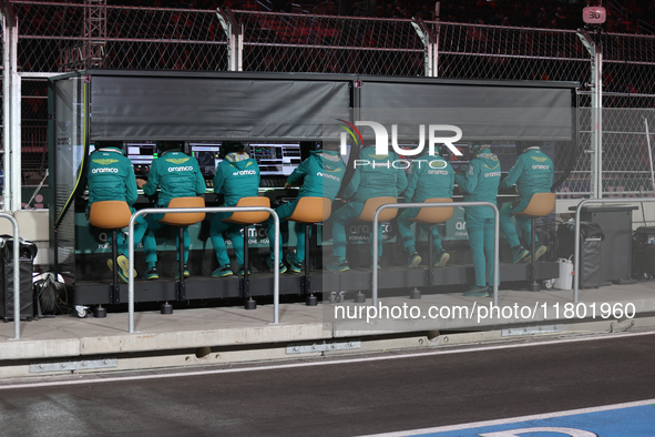 The Aston Martin team observes data screens while Fernando Alonso drives in the third Free Practice session of the Formula 1 Heineken Silver...