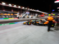 Lando Norris emerges from the McLaren garage during the third Free Practice session of the Formula 1 Heineken Silver Las Vegas Grand Prix in...