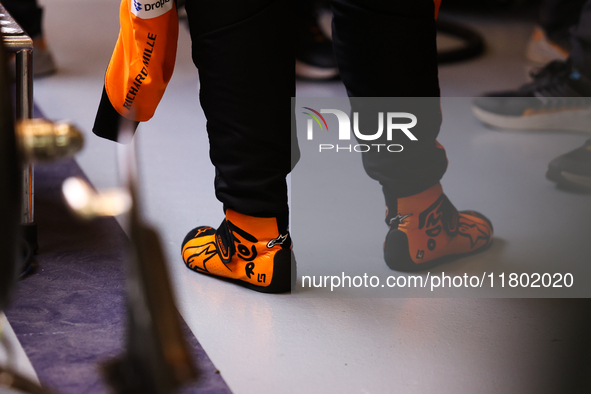 Lando Norris wears branded racing shoes in the McLaren garage during the third Free Practice session of the Formula 1 Heineken Silver Las Ve...