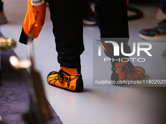 Lando Norris wears branded racing shoes in the McLaren garage during the third Free Practice session of the Formula 1 Heineken Silver Las Ve...