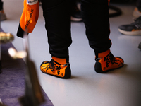 Lando Norris wears branded racing shoes in the McLaren garage during the third Free Practice session of the Formula 1 Heineken Silver Las Ve...