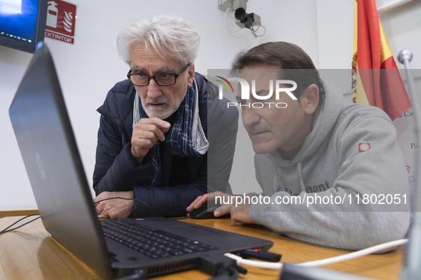 A technician helps Professor Angelo Torre, a professor of modern history at the University of Eastern Piedmont in Italy, prepare the compute...