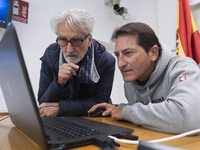 A technician helps Professor Angelo Torre, a professor of modern history at the University of Eastern Piedmont in Italy, prepare the compute...