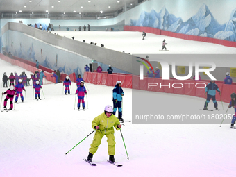 Tourists ski at the Kunlewan International Tourism Resort Ski Center in Handan, North China's Hebei province, on November 23, 2024. (