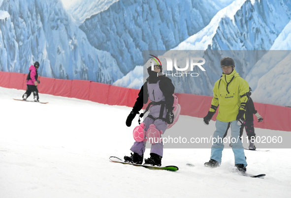 Tourists ski at the Kunlewan International Tourism Resort Ski Center in Handan, North China's Hebei province, on November 23, 2024. 