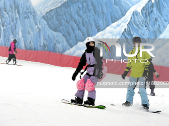 Tourists ski at the Kunlewan International Tourism Resort Ski Center in Handan, North China's Hebei province, on November 23, 2024. (