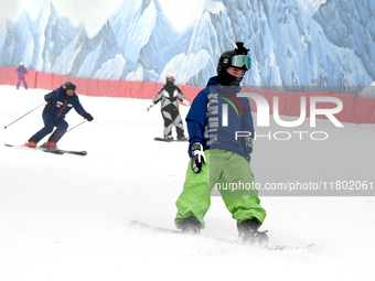 Tourists ski at the Kunlewan International Tourism Resort Ski Center in Handan, North China's Hebei province, on November 23, 2024. (