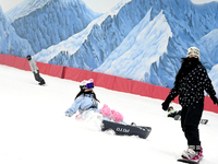 Tourists ski at the Kunlewan International Tourism Resort Ski Center in Handan, North China's Hebei province, on November 23, 2024. (