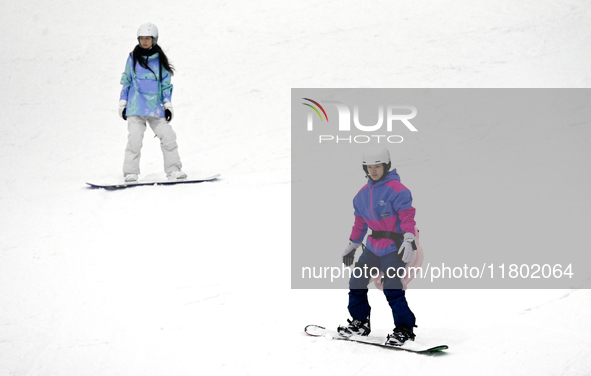 Tourists ski at the Kunlewan International Tourism Resort Ski Center in Handan, North China's Hebei province, on November 23, 2024. 