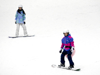 Tourists ski at the Kunlewan International Tourism Resort Ski Center in Handan, North China's Hebei province, on November 23, 2024. (