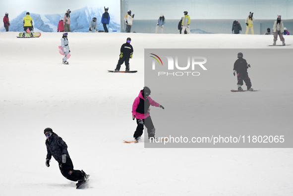 Tourists ski at the Kunlewan International Tourism Resort Ski Center in Handan, North China's Hebei province, on November 23, 2024. 