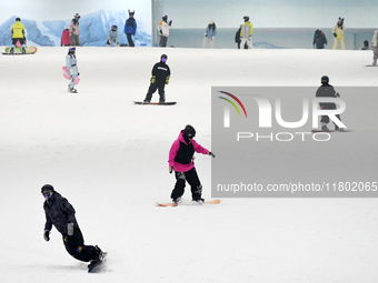 Tourists ski at the Kunlewan International Tourism Resort Ski Center in Handan, North China's Hebei province, on November 23, 2024. (