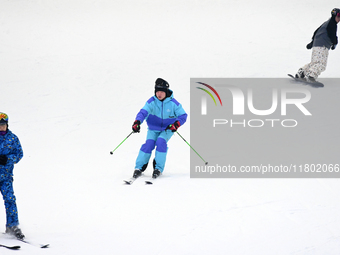 Tourists ski at the Kunlewan International Tourism Resort Ski Center in Handan, North China's Hebei province, on November 23, 2024. (