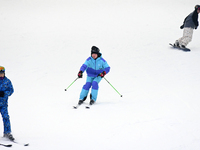 Tourists ski at the Kunlewan International Tourism Resort Ski Center in Handan, North China's Hebei province, on November 23, 2024. (