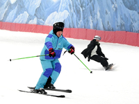 Tourists ski at the Kunlewan International Tourism Resort Ski Center in Handan, North China's Hebei province, on November 23, 2024. (