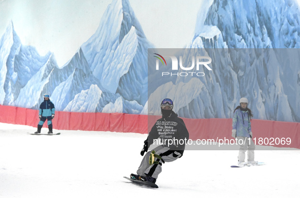 Tourists ski at the Kunlewan International Tourism Resort Ski Center in Handan, North China's Hebei province, on November 23, 2024. 