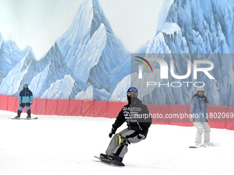 Tourists ski at the Kunlewan International Tourism Resort Ski Center in Handan, North China's Hebei province, on November 23, 2024. (