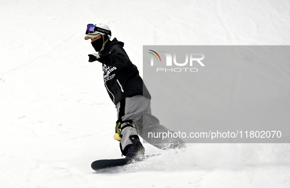 Tourists ski at the Kunlewan International Tourism Resort Ski Center in Handan, North China's Hebei province, on November 23, 2024. 