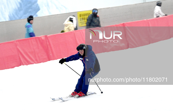 Tourists ski at the Kunlewan International Tourism Resort Ski Center in Handan, North China's Hebei province, on November 23, 2024. 