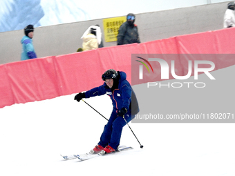 Tourists ski at the Kunlewan International Tourism Resort Ski Center in Handan, North China's Hebei province, on November 23, 2024. (