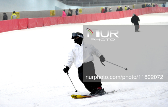 Tourists ski at the Kunlewan International Tourism Resort Ski Center in Handan, North China's Hebei province, on November 23, 2024. 