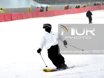 Tourists ski at the Kunlewan International Tourism Resort Ski Center in Handan, North China's Hebei province, on November 23, 2024. (