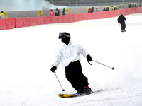 Tourists ski at the Kunlewan International Tourism Resort Ski Center in Handan, North China's Hebei province, on November 23, 2024. (