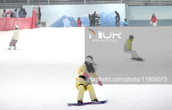 Tourists ski at the Kunlewan International Tourism Resort Ski Center in Handan, North China's Hebei province, on November 23, 2024. 