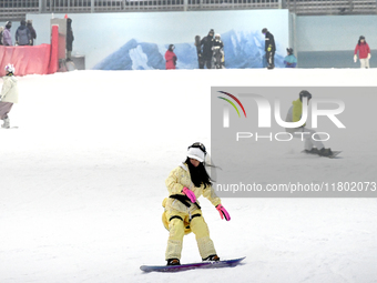 Tourists ski at the Kunlewan International Tourism Resort Ski Center in Handan, North China's Hebei province, on November 23, 2024. (