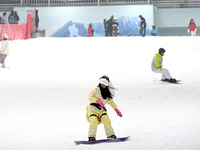 Tourists ski at the Kunlewan International Tourism Resort Ski Center in Handan, North China's Hebei province, on November 23, 2024. (