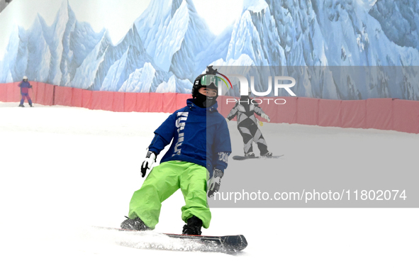 Tourists ski at the Kunlewan International Tourism Resort Ski Center in Handan, North China's Hebei province, on November 23, 2024. 