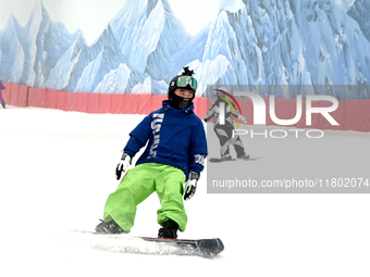 Tourists ski at the Kunlewan International Tourism Resort Ski Center in Handan, North China's Hebei province, on November 23, 2024. (