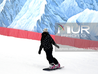 Tourists ski at the Kunlewan International Tourism Resort Ski Center in Handan, North China's Hebei province, on November 23, 2024. (