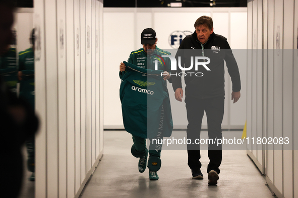 Fernando Alonso walks out of the FIA garage after qualifying during the Formula 1 Heineken Las Vegas Grand Prix in Las Vegas, Nevada. 