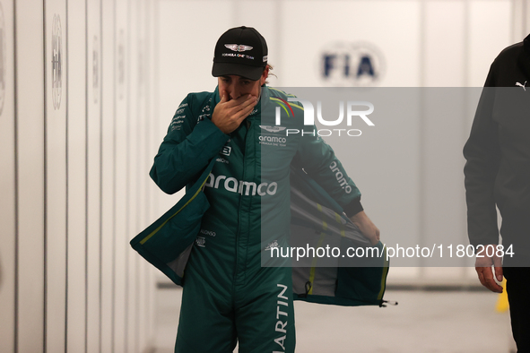 Fernando Alonso walks out of the FIA garage after qualifying during the Formula 1 Heineken Las Vegas Grand Prix in Las Vegas, Nevada. 