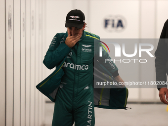 Fernando Alonso walks out of the FIA garage after qualifying during the Formula 1 Heineken Las Vegas Grand Prix in Las Vegas, Nevada. (