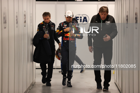 Sergio Perez walks out of the FIA garage after qualifying during the Formula 1 Heineken Las Vegas Grand Prix in Las Vegas, Nevada. 