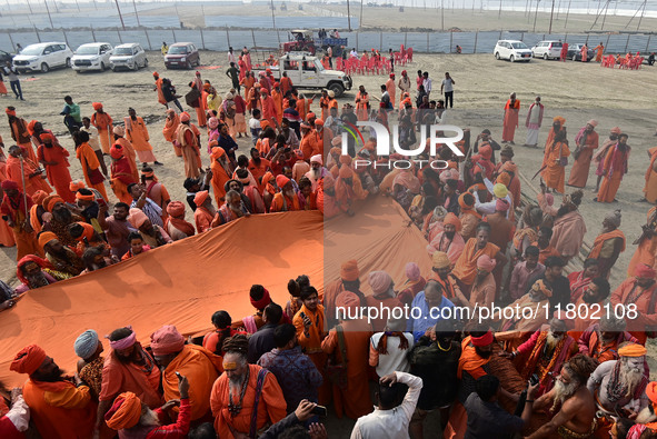 Indian Sadhus (Hindu holy men) gather during the Dharam Dhwaja (religious flag) ceremony at the Sangam area, ahead of the upcoming Maha Kumb...