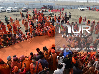 Indian Sadhus (Hindu holy men) gather during the Dharam Dhwaja (religious flag) ceremony at the Sangam area, ahead of the upcoming Maha Kumb...