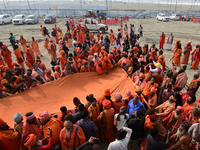 Indian Sadhus (Hindu holy men) gather during the Dharam Dhwaja (religious flag) ceremony at the Sangam area, ahead of the upcoming Maha Kumb...