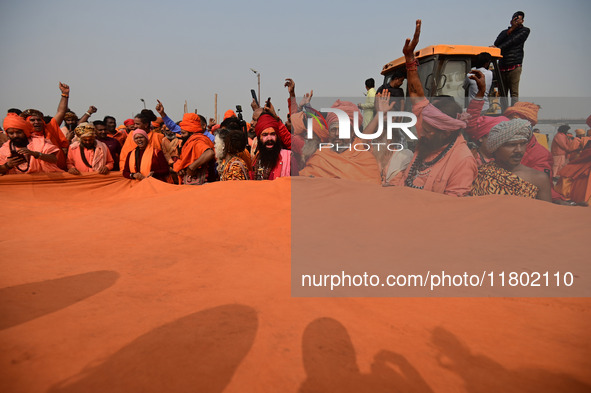 Indian Sadhus (Hindu holy men) gather during the Dharam Dhwaja (religious flag) ceremony at the Sangam area, ahead of the upcoming Maha Kumb...