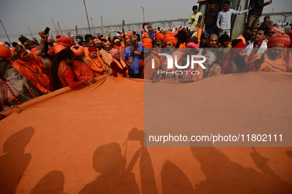 Indian Sadhus (Hindu holy men) gather during the Dharam Dhwaja (religious flag) ceremony at the Sangam area, ahead of the upcoming Maha Kumb...