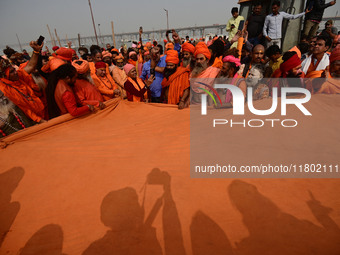 Indian Sadhus (Hindu holy men) gather during the Dharam Dhwaja (religious flag) ceremony at the Sangam area, ahead of the upcoming Maha Kumb...