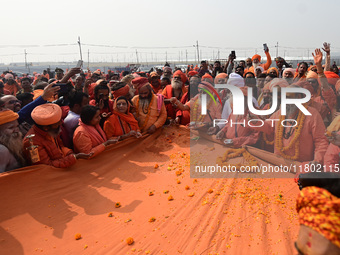 Indian Sadhus (Hindu holy men) gather during the Dharam Dhwaja (religious flag) ceremony at the Sangam area, ahead of the upcoming Maha Kumb...