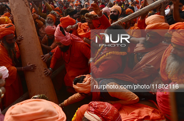 Indian Sadhus (Hindu holy men) gather during the Dharam Dhwaja (religious flag) ceremony at the Sangam area, ahead of the upcoming Maha Kumb...